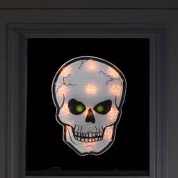 Northlight 12 in. Silver and Black Holographic Lighted Skull Halloween Window Silhouette Decoration thumbnail 2