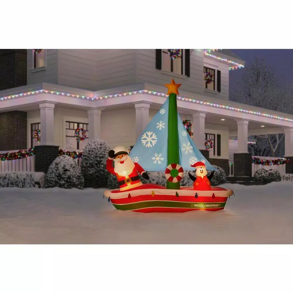 Home Accents Holiday 7 ft. Pre-Lit LED Inflatable Santa in Sailboat with Penguin Christmas Decoration